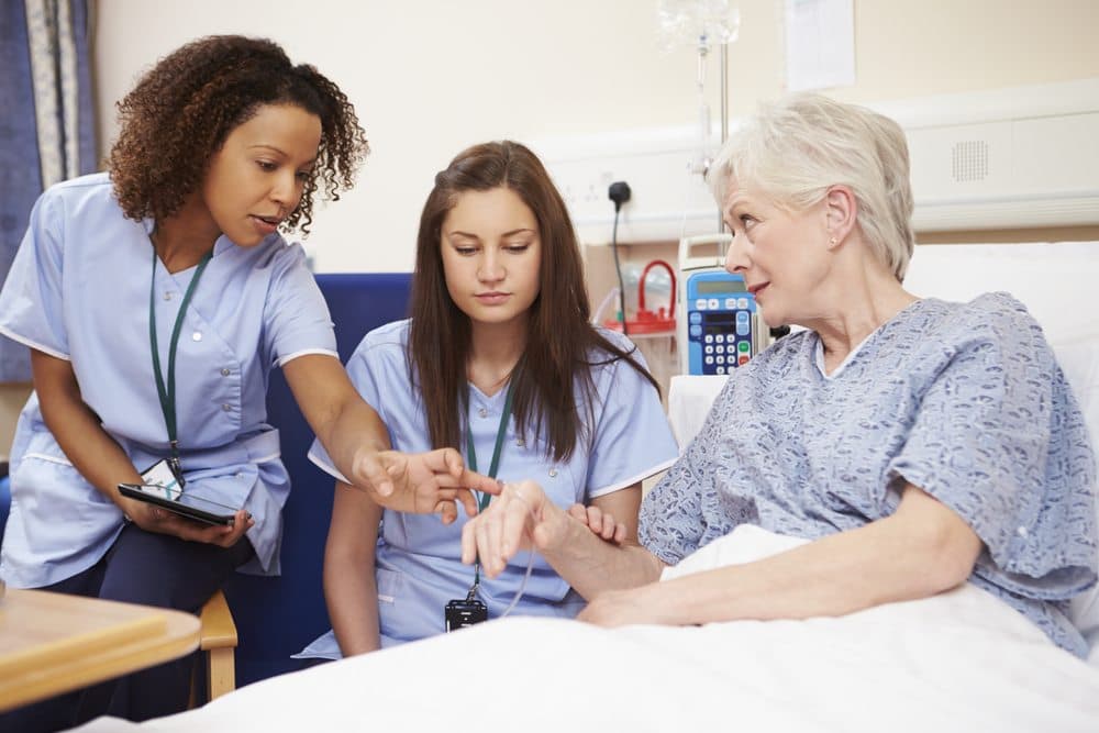 nurse-training-another-nurse-with-patient