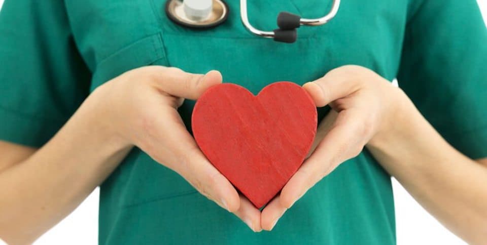 nurse-holding-wooden-heart-in-hand