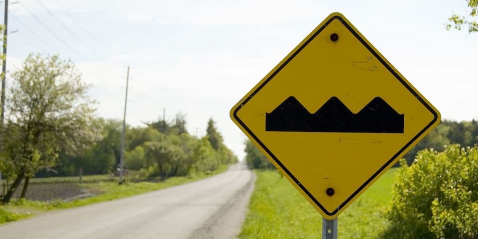 yellow-caution-sign-bumpy-road-ahead