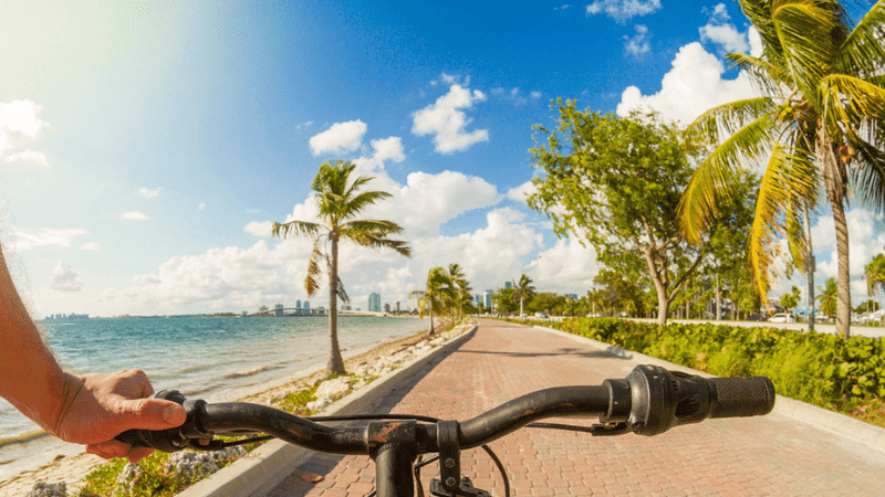 person-bikes-down-Miami-boardwalk-in-Florida