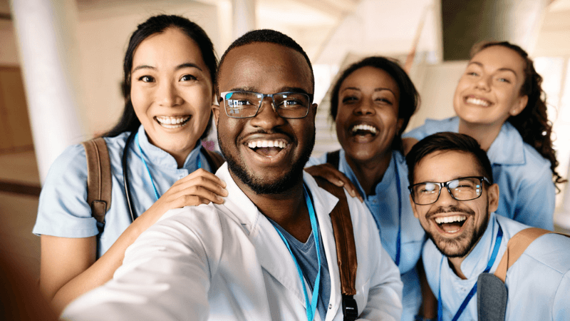 travel nurses and staff nurses work happily together