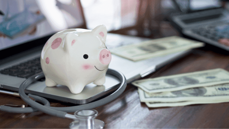Piggy bank money and nurse stethoscope